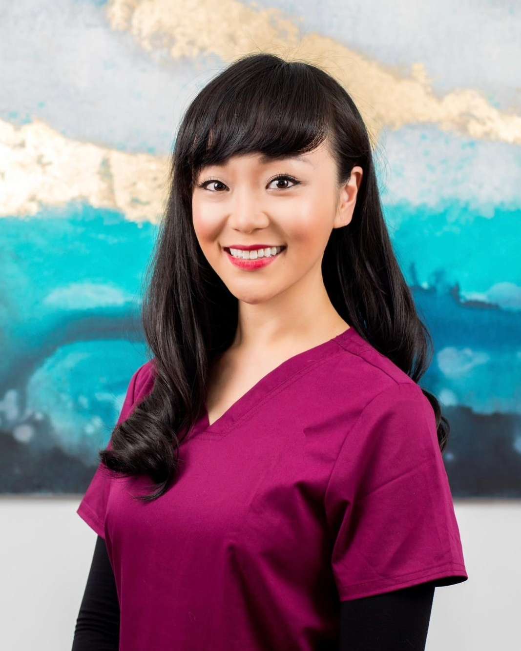 dr mini li female dentist with maroon uniform